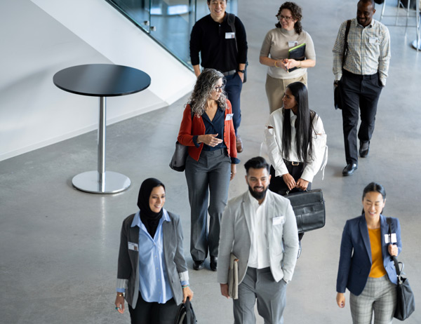 A group of people walk together through a lobby