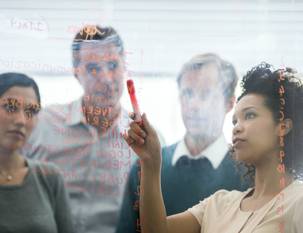 A group of people standing having an interactive discussion