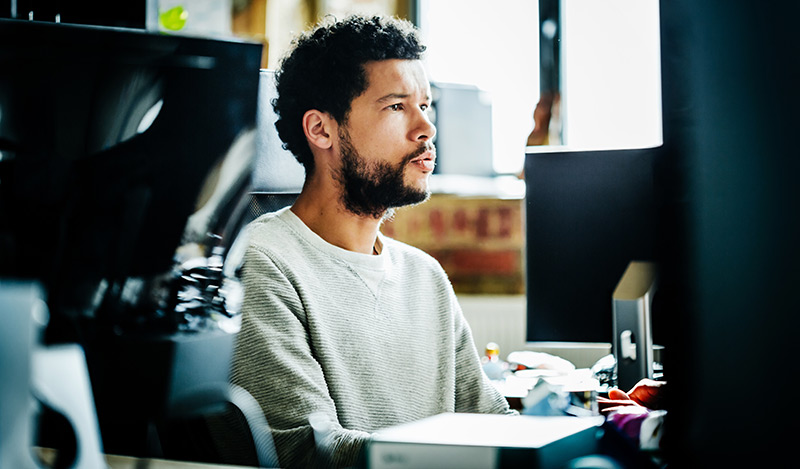 A man sits at his desk working