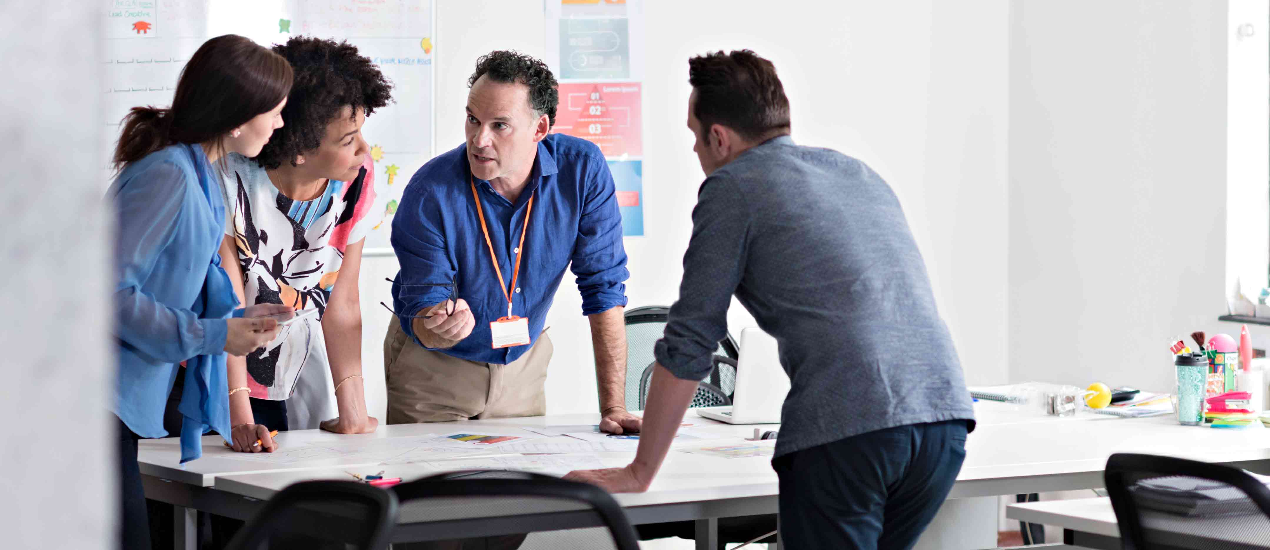 A group of people standing having an interactive discussion