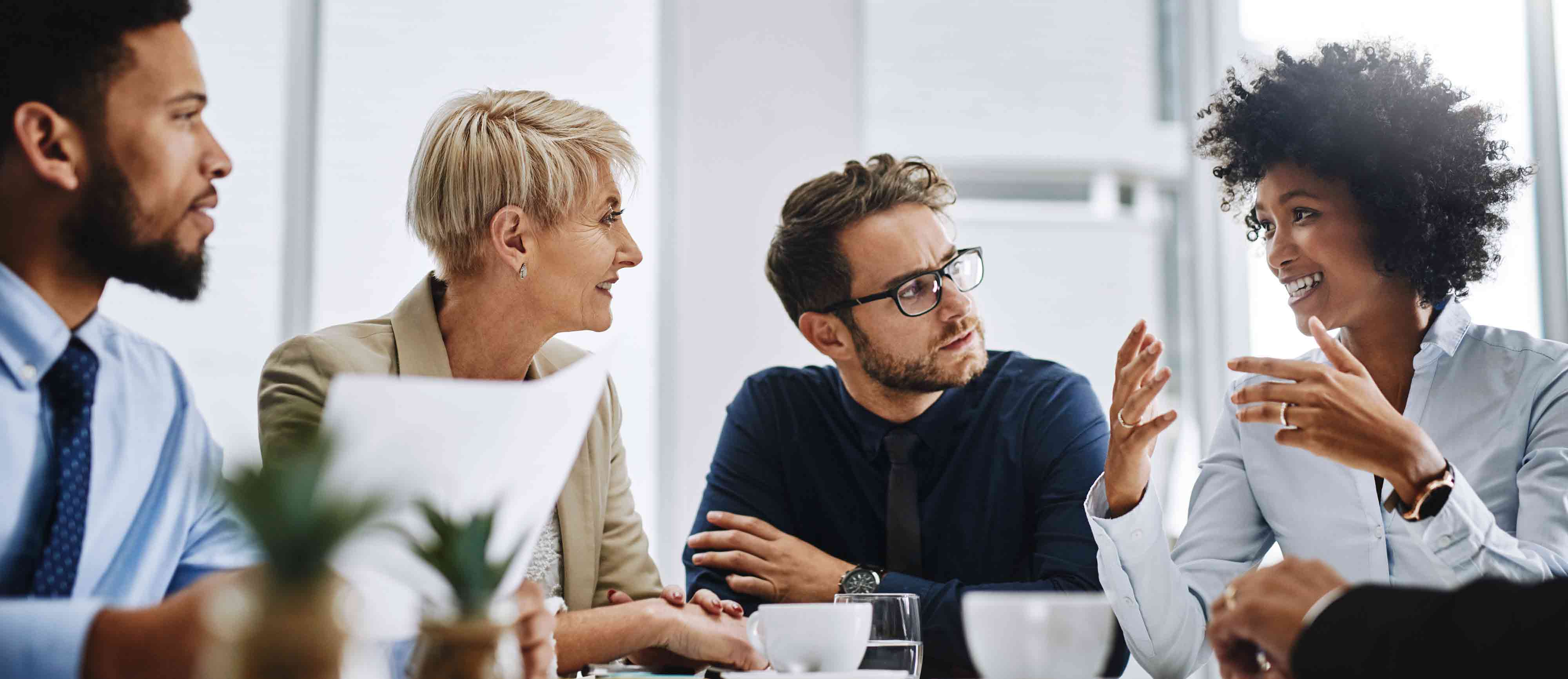 A group of people have an interactive discussion around a table