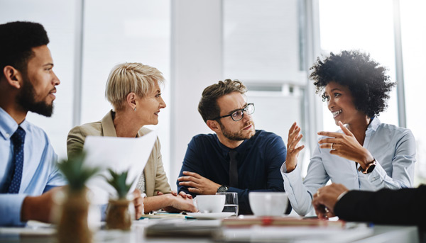 A group of people have an interactive discussion around a table