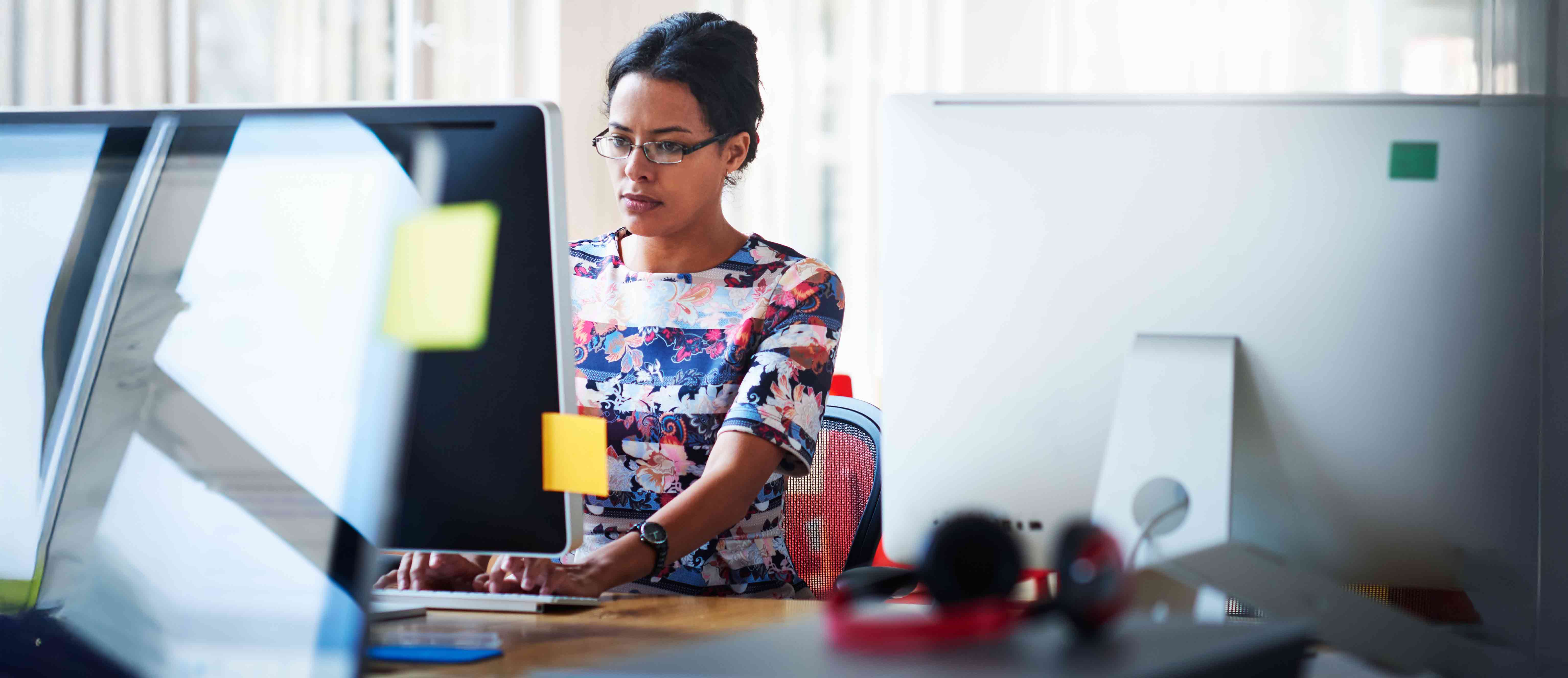 Woman sits at desk typing