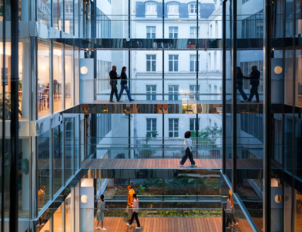 People walking through an office building
